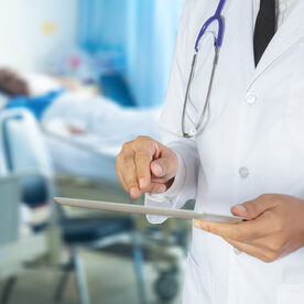 Healthcare and Medicine, Doctor using a digital tablet in patient room